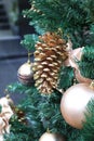 Golden winter decorations hanging on Christmas tree. Holiday and celebration creative concept. Royalty Free Stock Photo