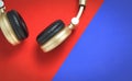 Golden Wireless Audio headphone on red and blue Royalty Free Stock Photo