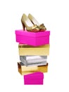 Golden Woman Shoes on top of stacked boxes isolated