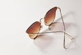 Golden women sunglasses isolated on the white background