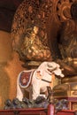 Golden wooden statue depicting the bodhisattva Fugen depicted riding on a white elephant symbol of firmness in the Tendai Buddhism