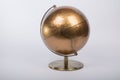 Golden World atlas globe isolated on a gray background Royalty Free Stock Photo