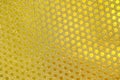 Golden wrapping paper, flickering small circles pattern as background or texture