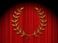 Golden wreath on red theater curtain