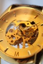 Golden wrist mechanical watch close-up on a white background. Clock face. Time.