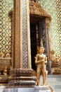 Golden yaksha statue near entrance to Phra Mondop building
