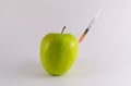 Golden Yellow Apple and Hypodermic Poison Syringe Royalty Free Stock Photo