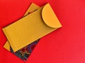 Golden yellow color Chinese New Year envelopes with red background. Chinese New Year festival concept.