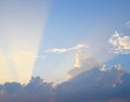 Golden Yellow Crepuscular Sun Rays from Dark Clouds in Blue Sky - Natural Background Skyscape Royalty Free Stock Photo