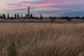 Colorful sunset clouds over yellow field grass of Tempelhof aiport field in Berlin