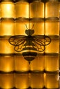 Golden yellow honey in glass jar on wooden board Closeup Copy space with bee logo