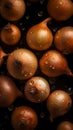 Golden-yellow onion on a dark background, covered in water droplets.