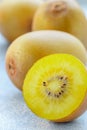 Golden yellow organic kiwi. Whole and cut ripe juicy fruits on grey background. kiwifruit Royalty Free Stock Photo