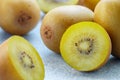 Golden yellow organic kiwi. Whole and cut ripe juicy fruits on grey background. kiwifruit Royalty Free Stock Photo