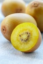 Golden yellow organic kiwi. Whole and cut ripe juicy fruits on grey background. kiwifruit Royalty Free Stock Photo