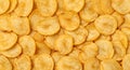 Golden-yellow potato chips with a crispy texture are densely layered in the image. Each Royalty Free Stock Photo