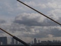 Golden yellow slinks and turquoise silver sky, clouds and gray-black buildings, white light. Royalty Free Stock Photo