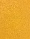 Golden yellow stone grain wall spray painted texture concrete background in retro style