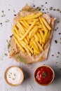 Golden yummy deep french fries on kraft baking sheet paper