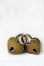 Two golden heart padlocks on wooden backrgound Royalty Free Stock Photo