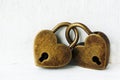 Two golden heart padlocks on wooden backrgound Royalty Free Stock Photo