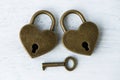 Two golden heart padlocks on wooden backrgound Royalty Free Stock Photo