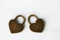 Two golden heart padlocks on wooden backrgound Royalty Free Stock Photo