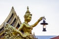 Goldent Ginnaree statue art holding a lamp. Royalty Free Stock Photo