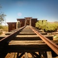 Goldfield Gold Mine`s old entrance to a gold mine shaft with rails leading inside, surrounded by cactuses Royalty Free Stock Photo