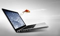 Goldfish jump out of the monitor Royalty Free Stock Photo