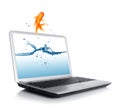 Goldfish jumping from monitor Royalty Free Stock Photo