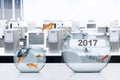 Goldfish jumping to aquarium with number 2017