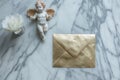 goldleaf envelope on marble with cupid figurine