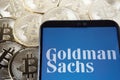 Goldman Sachs logo seen on the smartphone which is placed on the Bitcoin coins. Concept. Stafford, United Kingdom, April 7, 2021 Royalty Free Stock Photo