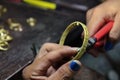 Goldsmith use Pliers cutting Bracelets. Royalty Free Stock Photo
