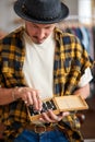 handsome young goldsmith working on a handmade jewelry in a workshop Royalty Free Stock Photo