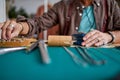 experienced young goldsmith working on a handmade jewelry in a workshop, cropped Royalty Free Stock Photo