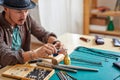 experienced young goldsmith working on a handmade jewelry in a workshop Royalty Free Stock Photo