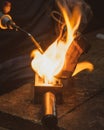 Goldsmiths melting metal with fire to produce rings, in artisan work.