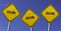 Golems - three yellow signs with blue sky background Royalty Free Stock Photo