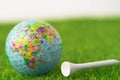 Golf Africa globe world ball with tee on green lawn or field