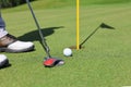 Golf approach shot with iron from fairway at sunny day Royalty Free Stock Photo