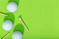 Group of golf balls and tee on green background