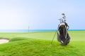 Golf bag and Golf Accessories Golf Set at golf course blue sea and blue sky as background Royalty Free Stock Photo