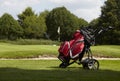 Golf bag with several clubs on a trolley on the fairway Royalty Free Stock Photo