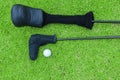 Golf bags and golf ball on a tee in green grass course Royalty Free Stock Photo