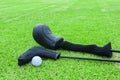 Golf bags and golf ball on a tee in green grass course Royalty Free Stock Photo