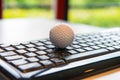 Golf ball with black computer keyboard