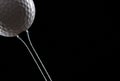 Golf ball black on tee Royalty Free Stock Photo