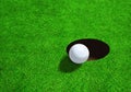 Golf Ball Close to Hole With Copy Space Royalty Free Stock Photo